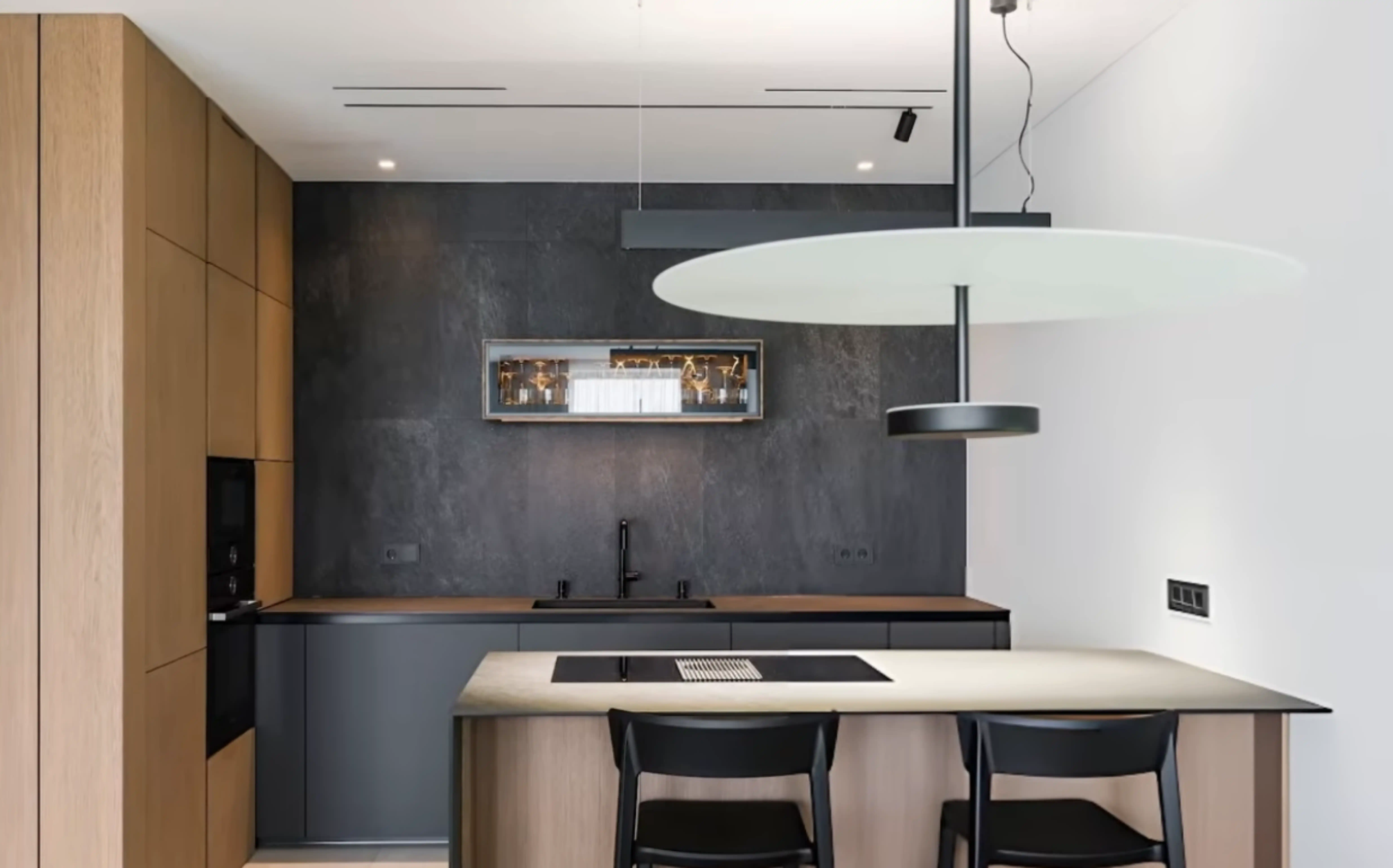 Modern Bellevue condo kitchen remodel featuring natural oak flat-panel cabinetry, slate gray quartz countertops, and minimalist integrated appliances.