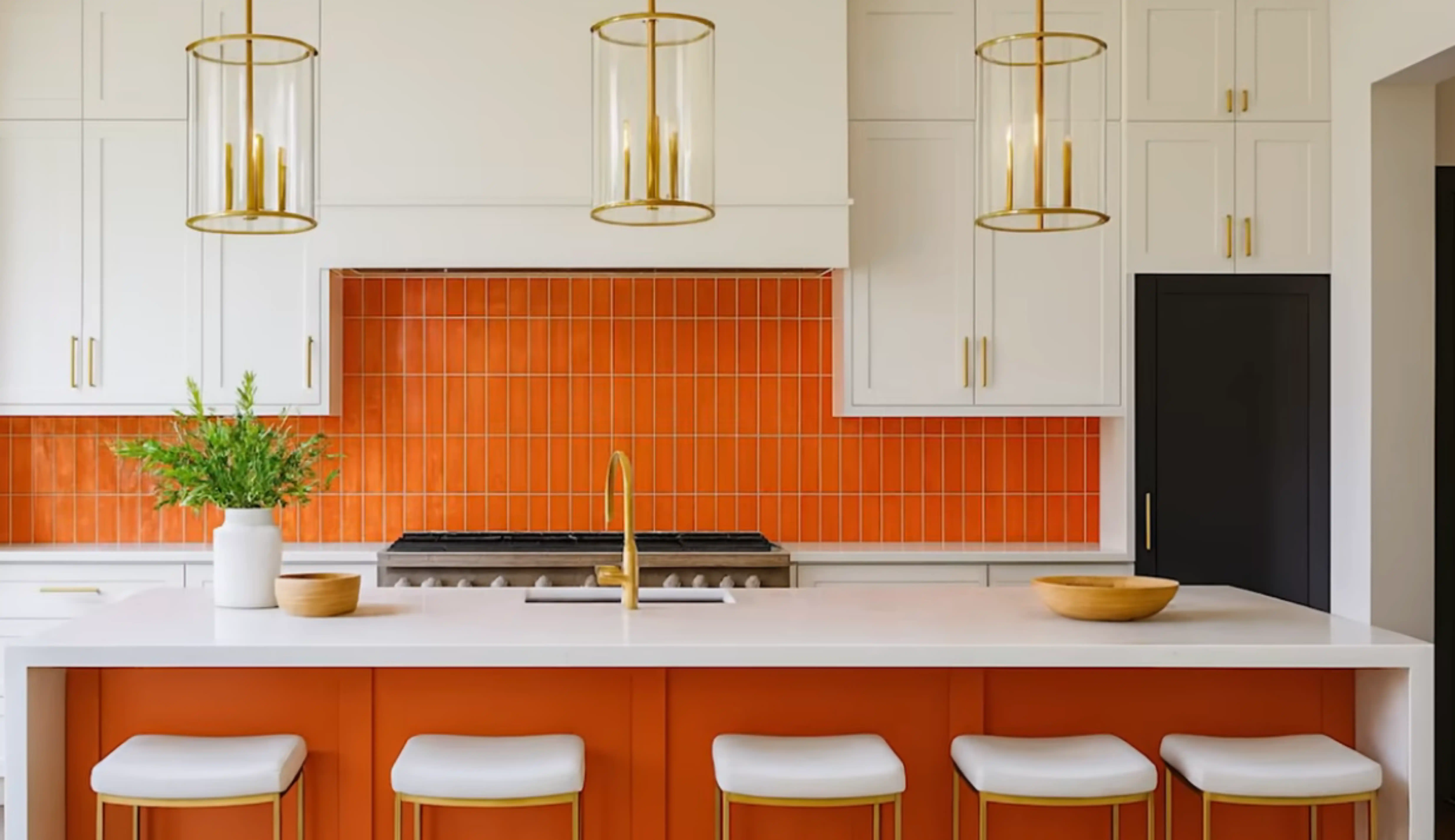 Warm transitional kitchen remodel with artisan glazed orange tile backsplash, clean white shaker cabinets, and generous quartz island.